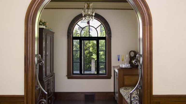 Close up of wooden arch way looking at window