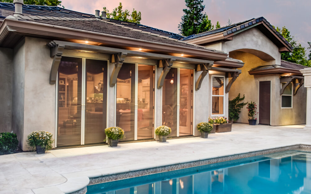 Set of Phantom Screens retractable doors screens on a Mediterranean style home.