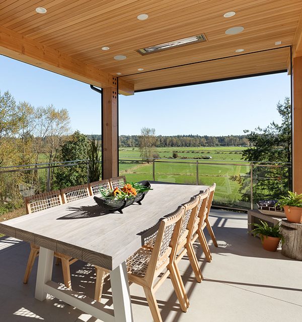 Large dining table on enclosed patio with retractable motorized screens