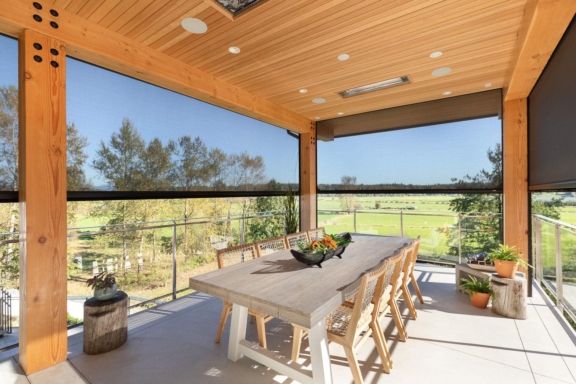 Large dining table on enclosed patio with retractable motorized screens