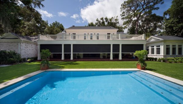 Large backyard of home with disappearing motorized patio screens