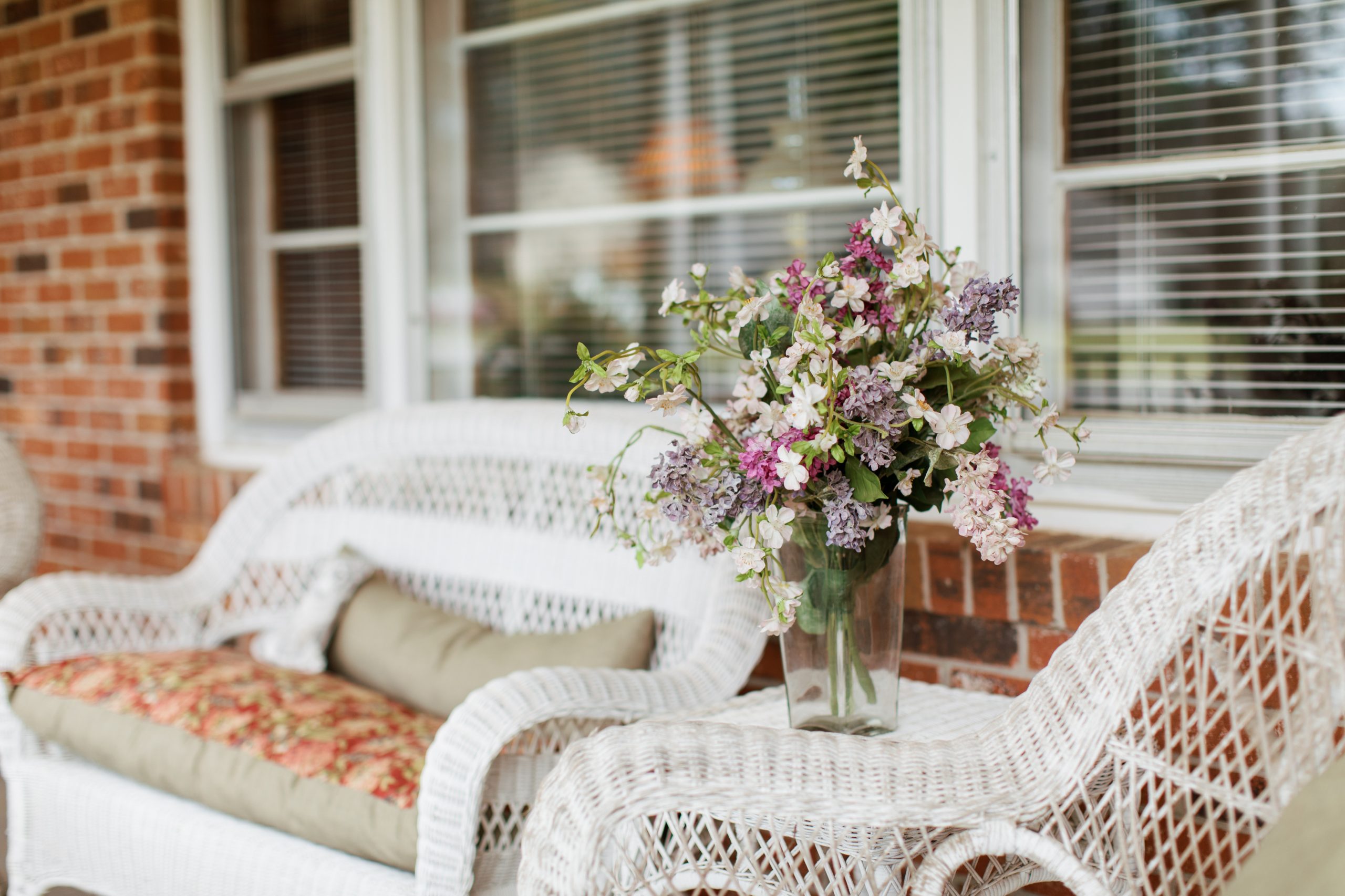 Stock image of flower vase sitting on wicker furniture